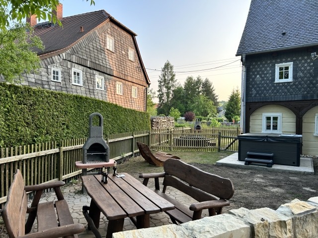 Eigener Gartenbereich der Fewo mit rustikaler Sitzecke aus massiver Eiche