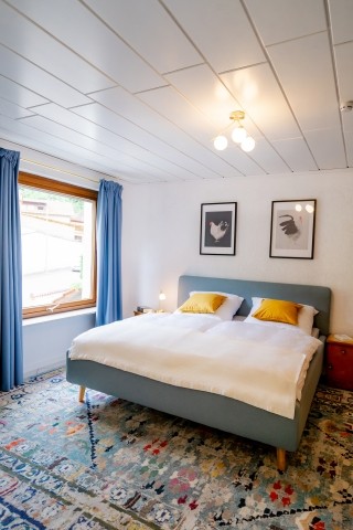 Schlafzimmer mit Kung-Size Bett und aufgearbeiteten Vintage-Möbeln