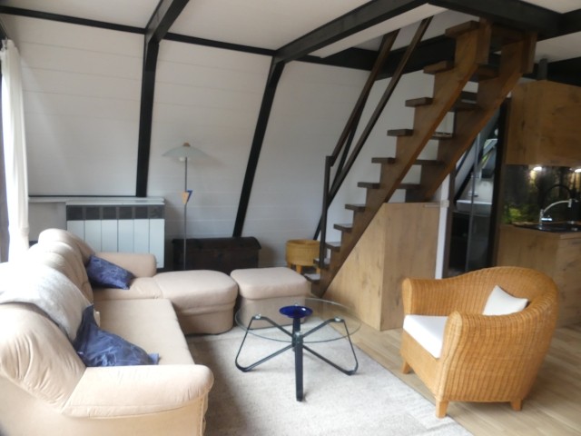 Gemütliches Wohnzimmer mit Treppe zu den Schlafzimmern