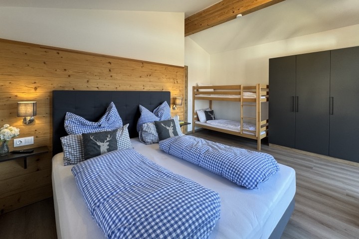 Schlafzimmer mit Doppelbett und Stockbett