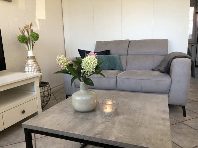 Wohnbereich mit 2 zweier Sofas, TV und Schreibtisch