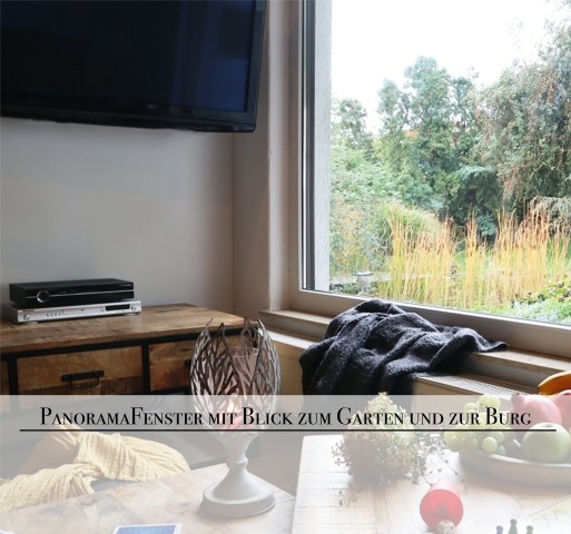 Wohnzimmer mit Panoramablick zum eigenen Garten