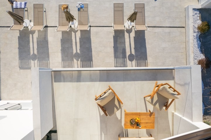 A terrace overlooking the pool and natural surroundings, perfect for morning coffee or evening relaxation.