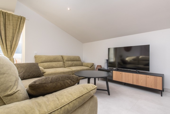 Another open-plan living area with a terrace overlooking the pool and natural surroundings, perfect for morning coffee or evening relaxation.