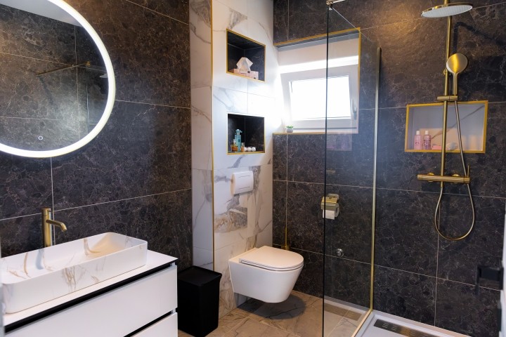 The bedrooms share a modern bathroom with a walk-in shower and contemporary design.