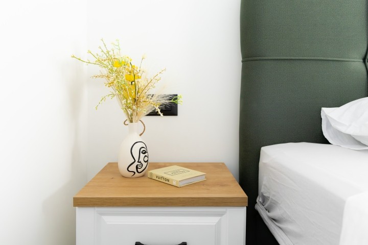 The bedroom features a clean, minimalist style for a peaceful stay.